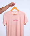 Front of Aunt Flow peach color t-shirt on a clothing hanger.
